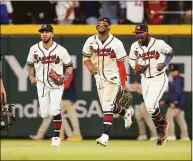  ?? Brett Davis / Associated Press ?? From left, Atlanta Braves outfielder­s Eddie Rosario, Ronald Acuna Jr. and Michael Harris II celebrate after a victory against the Mets.