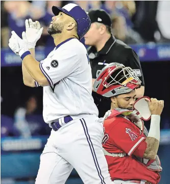  ?? FRANK GUNN THE CANADIAN PRESS ?? Blue Jays designated hitter Kendrys Morales celebrates after hitting a two-run home run against Los Angeles Angels starting pitcher Garrett Richards, scoring teammate Russell Martin, in first-inning American League baseball action in Toronto on Tuesday...