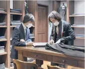  ?? NIROKO HAYASHI/THE NEW YORK TIMES ?? Japan’s government wants employers to raise wages. Above, an employee meets with a customer at Yoshimura & Sons, a tailor in Tokyo.