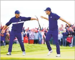  ?? RICHARD HEATHCOTE GETTY IMAGES ?? Bryson Dechambeau (left) and Scottie Scheffler of the U.S. team celebrate on 15th green during their comeback to beat Viktor Hovland and Tommy Fleetwood.