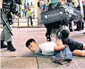  ??  ?? Police officers detain protesters during a rally against a new national security law in Hong Kong