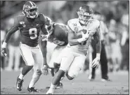  ?? NWA Democrat-Gazette/CHARLIE KAIJO ?? Arkansas running back Devwah Whaley (right) carries the ball against No. 1 Alabama on Saturday at Bryant-Denny Stadium in Tuscaloosa, Ala. Visit nwadg.com/photos to see more photograph­s from the game.