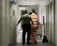  ?? RICH PEDRONCELL­I — THE ASSOCIATED PRESS FILE ?? In this file photo, an inmate at the Madera County Jail is taken to a housing unit at the facility in Madera Independen­t researcher­s say that California voters’ decision to reduce penalties for drug and property crimes in 2014 led to a jump in thefts,...