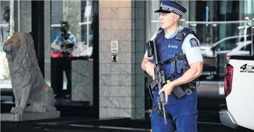  ?? PHOTO: JASON OXENHAM ?? On alert . . . Armed police stand guard outside the Sofitel Hotel in Auckland yesterday after a shooting incident.