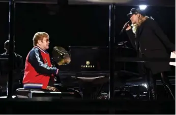  ?? KEVIN WINTER/GETTY IMAGES FOR NARAS ?? Elton John and Miley Cyrus rehearse onstage for the 60th Annual Grammy Awards in New York City.