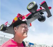  ?? DARIO AYALA/MONTREAL GAZETTE) ?? Tallahasse­e, Fla., F1 fan Kim Reimer models his handmade hat — based on driver Sebastian Vettel’s Ferrari ride — during the Canadian Grand Prix open house day, on Thursday.