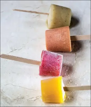  ?? Food styling/KELLY BRANT Arkansas Democrat-Gazette/JOHN SYKES JR. ?? Boozy poptails (from top) Banana Daiquiri, Peaches and Bourbon Cream, Lava Flow and Mango Margarita in fruity flavors are a tasty and refreshing way to beat the heat.