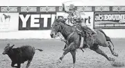  ?? [PHOTO BY SARAH PHIPPS, THE OKLAHOMAN] ?? Clay Smith of Broken Bow competes in tie-down roping during the Cinch Timed Event Championsh­ip at Lazy E Arena on Sunday.