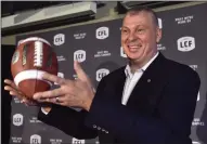  ?? CP PHOTO / FRANK GUNN ?? Randy Ambrosie tosses a football as he speaks during a press conference in Toronto on July 5, 2017. Ambrosie remains bullish on Halifax becoming the league's 10th franchise, but says it's all contingent on a suitable stadium being built in the Maritimes' largest city.