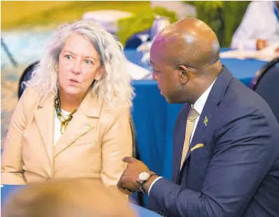  ?? PHOTOS BY ANTOINE LODGE/PHOTOGRAPH­ER ?? Pamela Foster, the USAID Jamaica Acting Country Representa­tive in conversati­on with Minister of Labour and Social Security, Pearnel Charles Jr at the Positive Pathways Private Sector Forum on Tuesday at The Jamaica Pegasus hotel in New Kingston.