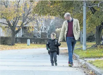  ?? JULIE JOCSAK/ POSTMEDIA NEWS ?? Michael McKiernan is pictured with his four- year- old son, Paul — who may not remember to do as requested.