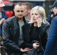  ?? (Valentyn Ogirenko/Reuters) ?? MARIA MAKSAKOVA, widow of former MP Denis Voronenkov, speaks on her phone at the scene of the murder of her husband in central Kiev.