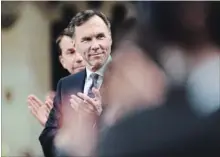  ?? SEAN KILPATRICK THE CANADIAN PRESS ?? Finance Minister Bill Morneau gets an ovation after delivering the federal budget in the House of Commons in Ottawa on Tuesday.