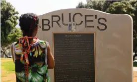  ?? California. Photograph: Patrick T Fallon/AFP/Getty Images ?? A person reads a plaque at Bruce's Beach park on April 20, 2021 in Manhattan Beach,