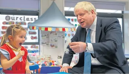  ?? Picture: PA. ?? The prime minister took a break from Brexit to visit St Mary’s and All Saints Primary School in Beaconsfie­ld, where he met four-yearold Scarlet Fickling.