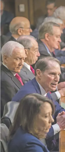  ?? J. SCOTT APPLEWHITE/ASSOCIATED PRESS FILE PHOTO ?? Sen. Ron Wyden, D-Ore., second from bottom, the top Democrat on the Senate Finance Committee, criticizes the Republican tax reform plan while Chairman Orrin Hatch, R-Utah, left, and GOP members, top, listen to his opening statement Monday on Capitol...