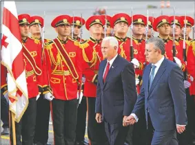  ?? AP/SHAKH AIVAZOV ?? Vice President Mike Pence (left) and Georgian Prime Minister Giorgi Kvirikashv­ili attend a welcome ceremony Monday at the airport outside Tbilisi, Georgia. Pence will meet the Georgian president and observe NATO-Georgian military exercises. Earlier on...