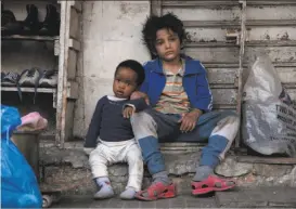  ?? Sony Pictures Classics ?? Zain Al Rafeea (right) plays Zain, who must take a hungry baby, played by Boluwatife Treasure Bankole, under his wing on the streets of Beirut in “Capernaum.”