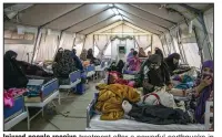  ?? (AP/MSF Afghanista­n) ?? Injured people receive treatment after a powerful earthquake in the Herat province of western Afghanista­n, on Sunday.