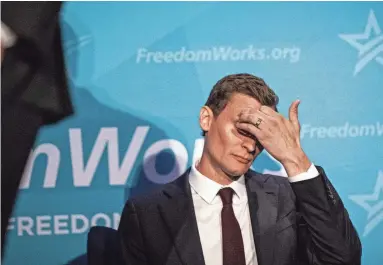  ?? ALBERTO MARIANI/THE REPUBLIC ?? Blake Masters scratches his head while an opponent candidate at the Republican primary debate for the U.S Senate speaks onstage at the Hyatt Regency hotel in Phoenix on June 23.