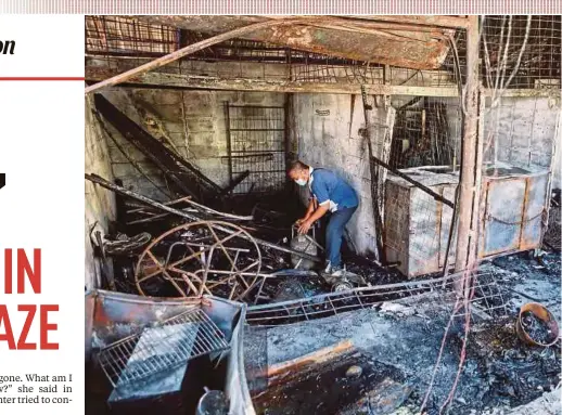  ?? PIC BY HAZREEN MOHAMAD ?? A man sifting through the charred items in his shop at Pasar Dato Keramat in Kuala Lumpur yesterday.