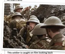  ??  ?? This soldier is caught on film looking back in trepidatio­n as he is about to go over the top with his fellow soldiers (colour by Peter Jackson)