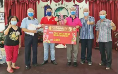  ??  ?? The person-incharge (third from right) of Pusat Jagaan Rumah Orang Tua Ampang received the contributi­on from Sports Toto representa­tive Dylan Ong (third from left).