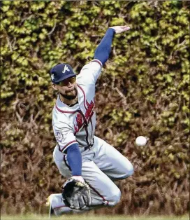  ?? DAVID BANKS / GETTY IMAGES ?? The Braves’ Ender Inciarte makes a catch on Javier Baez of the Cubs during the sixth inning of Monday’s game at Wrigley Field in Chicago.