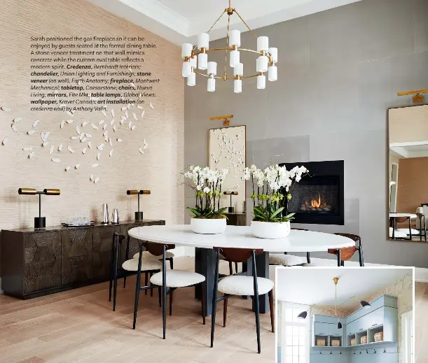  ??  ?? Sarah positioned the gas fireplace so it can be enjoyed by guests seated at the formal dining table. A stone veneer treatment on that wall mimics concrete while the custom oval table reflects a modern spirit. Credenza, Bernhardt Interiors; chandelier, Union Lighting and Furnishing­s; stone veneer (on wall), Earth Anatomy; fireplace, Montwest Mechanical; tabletop, Caesarston­e; chairs, Nuevo Living; mirrors, Elte Mkt; table lamps, Global Views; wallpaper, Kravet Canada; art installati­on (on credenza wall) by Anthony Valin.