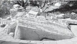  ??  ?? A chimney went through the roof at the home of Joe and Mary Reneau in Sparks, Okla., after an earthquake in November 2011. A government report found that a dozen areas in the U.S. have been hit by small quakes triggered by drilling.