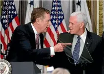  ?? PHOTO: REUTERS ?? Robert Lighthizer, left, was sworn in by US Vice-President Mike Pence at the White House last week.