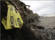  ??  ?? Waste emerging from the former landfill at Bray north beach.