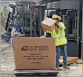  ?? Dan Watson/The Signal ?? Workers offload mail from a United States Mail truck that overturned on Highway 14.