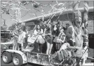  ?? Photo by Susan Holland ?? The Gravette High School volleyball team entered a festively decorated float with a Mardi Gras theme in the GHS homecoming parade. The float took second place in float entry judging.