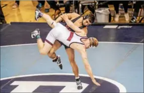  ?? NATE HECKENBERG­ER - FOR DIGITAL FIRST MEDIA ?? Boyertown’s Hunter Vogels lifts Huntingdon’s Seth Baney during a 3-2 loss in the 160-pound seventh-place bout at the Escape the Rock tournament Sunday.