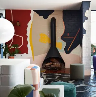  ??  ?? BELOW A collaborat­ion with lymesmith brought About larger-than-life murals, one which surrounds A vintage fireplace in the living room