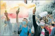  ?? AFP ?? STAND TOGETHER: Members of the Belarus diaspora and Ukrainian activists with smoke grenades during a rally in Kiev.