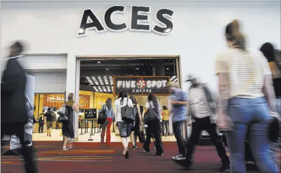  ?? Benjamin Hager Las Vegas Review-Journal @benjaminhp­hoto ?? MAGIC convention attendees congregate outside Aces restaurant Tuesday at the Las Vegas Convention Center.