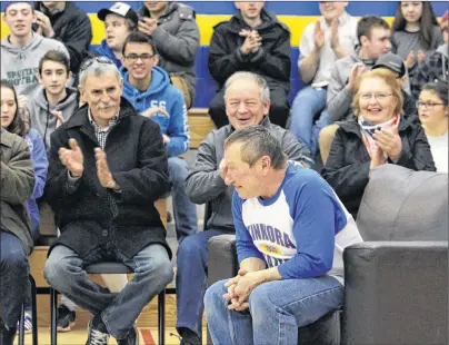  ?? MILLICENT MCKAY/JOURNAL PIONEER ?? Elmer Crocken, centre, smiles as students, staff and guests at Kinkora Regional High School applaud Crocken for being the sixth recipient of the P.E.I. Home and School Federation’s Extra Mile Award.