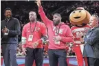  ?? ADAM CAIRNS/COLUMBUS DISPATCH ?? Michael Redd, Scoonie Penn and members of the 1998-99 Ohio State basketball team are recognized during Sunday's game at Value City Arena.