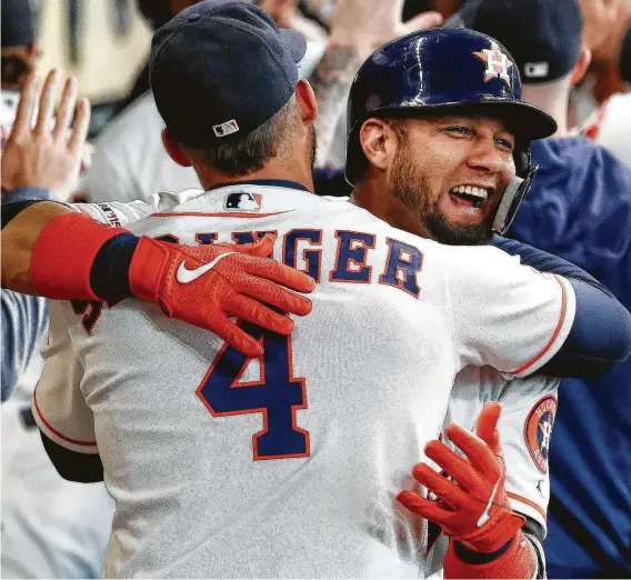  ?? Photos by KarenWarre­n / Staff photograph­er ?? Astros like George Springer were only getting started with their embracesWe­dnesday for Yuli Gurriel after he hit a three-run homer in the first inning.
