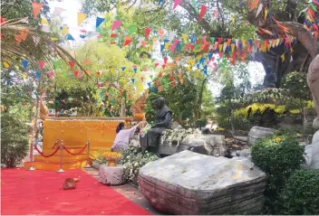  ??  ?? RITUALS. The gentle pouring of fragrant water on Buddha statues is an act of cleansing.