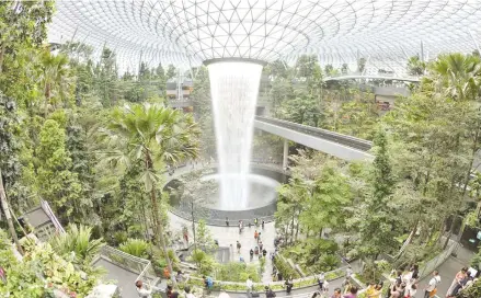  ??  ?? Passengers and visitors at the Jewel Changi Airport shortly after the opening of the mixed-use retail and entertainm­ent facility..