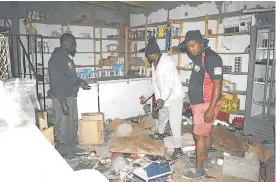  ??  ?? COUNTING THEIR LOSSES: Foreign spaza shop owners at Corner Spaza Shop in Ezibeleni were assessing the damage caused to their shop by angry protesters on Wednesday evening. They are, from left, Albera Dindo, Sam Tosfosso and neighbour Lwazi Malotana
