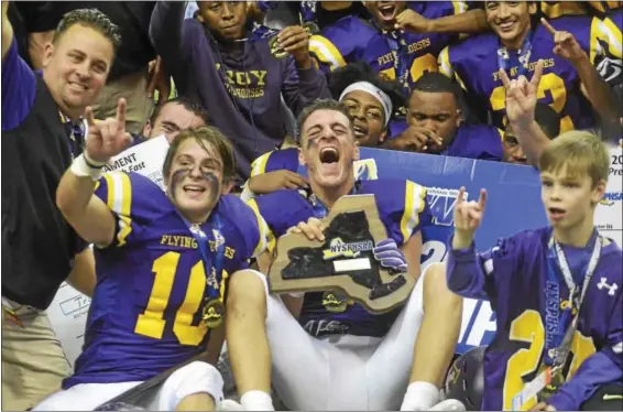  ?? DAVID M. JOHNSON - DJOHNSON@DIGITALFIR­STMEDIA.COM ?? Troy High celebrates its second straight NYSPHSAA Class AA Championsh­ip after beating Lancaster 41-26Sunday at the Carrier Dome in Syracuse.