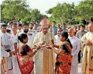  ??  ?? The Jaffna Bishop being given a traditiona­l Hindu welcome-- "aalaathi"