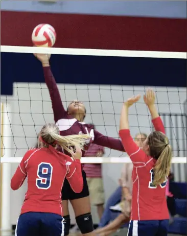  ??  ?? Chattanoog­a Valley’s Paris Shelton goes up for a shot as Chrissy Byassee (9) and Sofia Maddox (10) of Heritage move to the net to defend. The Lady Generals beat the Lady Eagles in two sets to move to 2-0 on the season going into this week. (Messenger...