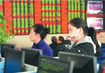  ?? WANG BIAO / FOR CHINA DAILY ?? Investors check stock prices at a brokerage in Fuyang, Anhui province. The top leadership’s call for sustainabl­e developmen­t and green economic growth has boosted investor sentiment toward companies involved in environmen­tally friendly businesses.