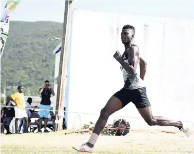  ?? GLADSTONE TAYLOR ?? Barrington Mitchell of Mount Olivet wins the Class One boys 200m Section One at the 2018 Council of Voluntary Social Services Summer Games at the UWI Bowl on Saturday.