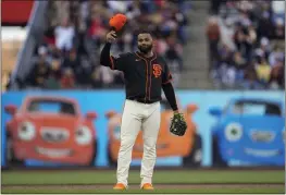  ?? GODOFREDO A. VÁSQUEZ — THE ASSOCIATED PRESS ?? Giants third baseman Pablo Sandoval gestures to fans after taking the field during the sixth inning of a spring training game against the Oakland A's on Tuesday in San Francisco.